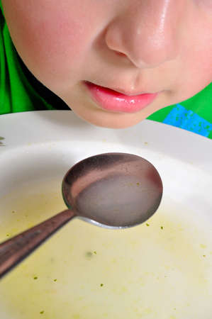 A close-up of a child during a meal                                   の写真素材