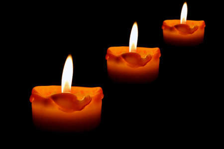 Beautiful, burning candles on a black backgroundの写真素材