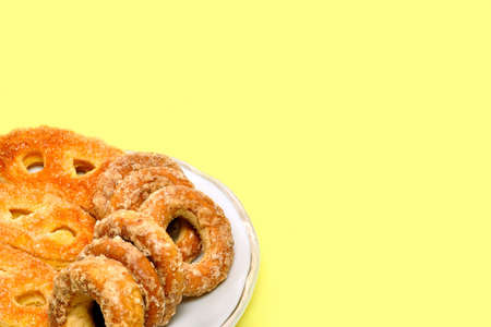 Various biscuit served on the plate. Yellow background.の写真素材
