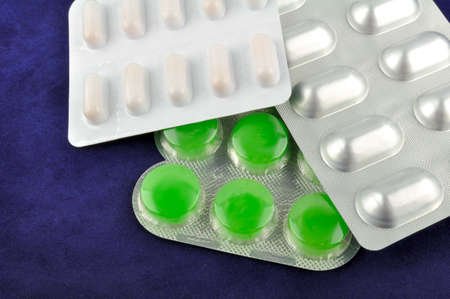 Various tablets (medicines) on the blue backgroundの写真素材