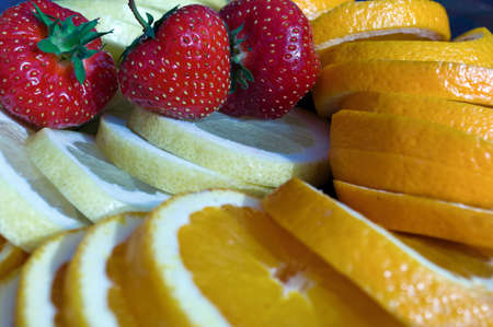 Summer dessert. Fresh strawberries, lemons and orangesの写真素材