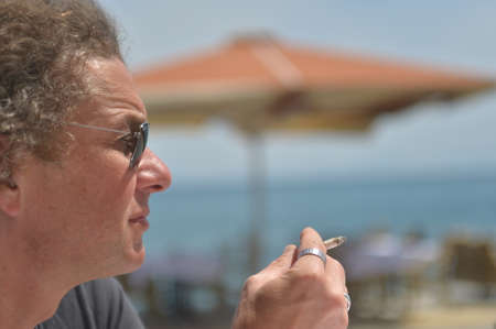 smoking on the beachの写真素材