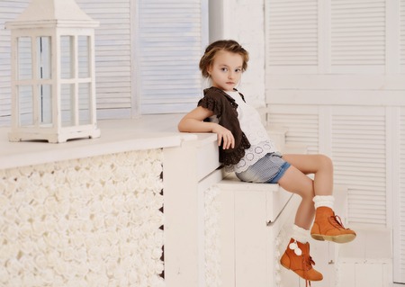 Little beautiful girl at her light homeの写真素材