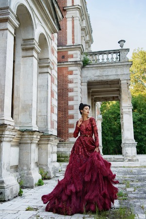Beautiful young witch in purple silk dressの写真素材