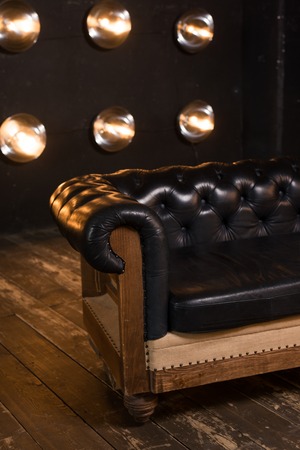 Black leather sofa in loft interiorの写真素材