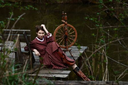 Pretty girl in long dress at the deep dark forestの写真素材