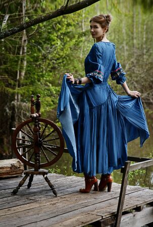 Pretty girl in long dress at the deep dark forestの写真素材