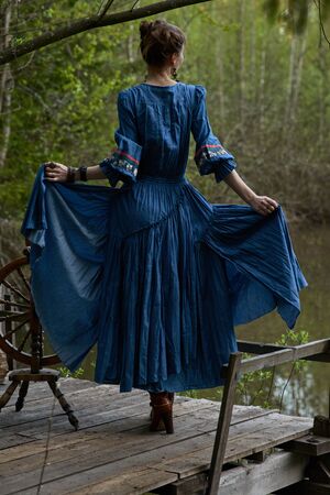 Pretty girl in long dress at the deep forestの写真素材