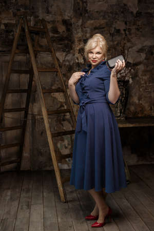 Attractive mature woman wearing blue dressの写真素材