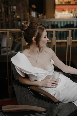 A young couple in love in wedding images posing in a stylish loft bar near the bar counter.の写真素材