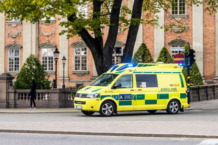 Stockholm, Stockholm/ Sweden-04MAY2019: Ambulance emergency bus drive to a call. Blue warning lights blinking in capital city of Stockholm. Bus in motion.のeditorial素材