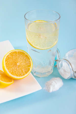 Baking soda in drinking glass with water and lemon juice, health benefits for digestive system...