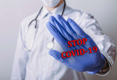 Medical doctor showing stop gesture to COVID-19 coronavirus.の写真素材