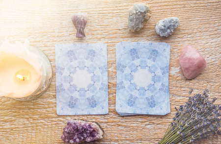 Deck with divination Angel cards on light wooden table, surrounded with semi precious stones...
