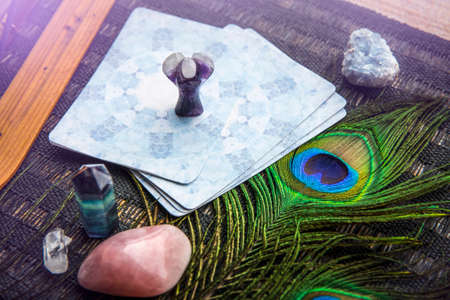Deck with divination homemade Angel cards on black table, surrounded with semi precious stones...
