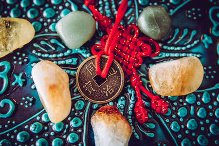 Chinese coin used as Feng Shui money cures attracting the energy of wealth and money concept. Wooden oriental background.の写真素材