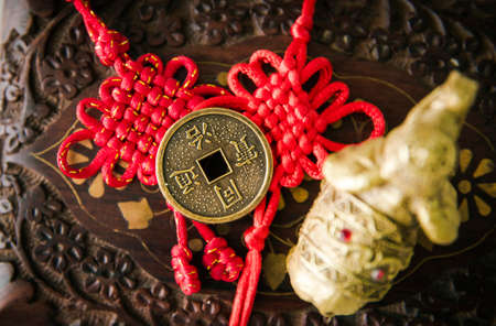 Chinese coin used as Feng Shui money cures attracting the energy of wealth and money concept. Wooden oriental background.の写真素材
