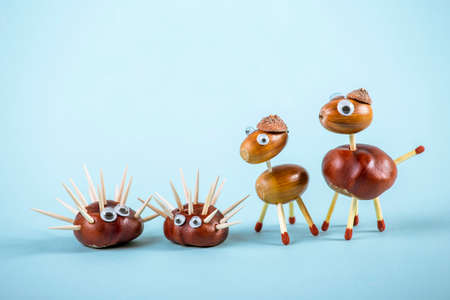 Modern family concept. Children and parents made of an natural horse chestnut and oak tree acorns....