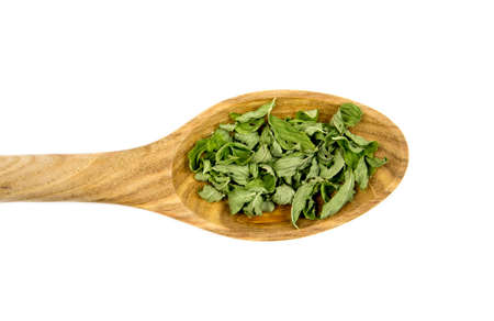 Dried green Peppermint (Mentha piperita) leaves on wooden spoon, herbal tea ingredient, isolated on white.の写真素材