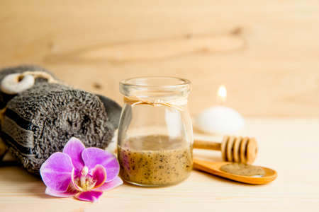 Selective focus on sauna honey scrub. Scrubbing honey and coffee mixture on body in hot sauna helps open the pores and renew, rejuvenate the skin on body. Sauna treatment concept.の写真素材