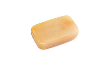 Removing stains with bile( gall, sap) soap bar. Natural chemical free household clothing washing products concept. Brown soap bar isolated on white.の写真素材