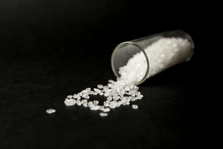Conceptual image of bath salts synthetic cathinones drugs narcotics concept. White crystal powder on...