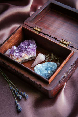 Witch tools inside beautiful old wood box. Rose quartz pendulum, natural amethyst and celestite...