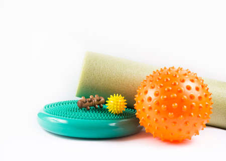 Massage yourself, composition of different tools isolated on white. Self-deep tissue massage concept. Spiky ball, foam roller, wooden roll, half balance rubber flat, full body massage tools.Copy spaceの写真素材