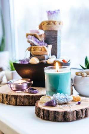 Relaxing spiritual Feng Shui altar set with nature, water and fire element. Tabletop small electrical fountain with water pouring cups. Symbol of wealth and prosperity.の写真素材