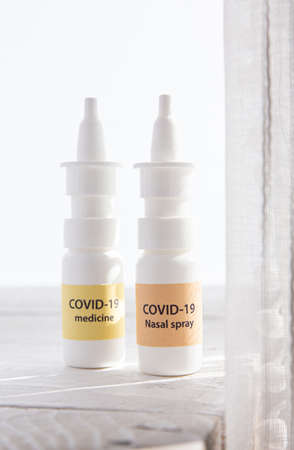 New treatment against Coronavirus COVID-19 (SARS-CoV) nasal spray and throat spray. Conceptual image of new innovative nasal spray bottles with text COVID-19 nasal spray and COVID-19 medicine.の写真素材