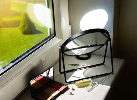 Harsh sunlight coming though window directly to mirror which can cause fire hazard at home concept.の写真素材