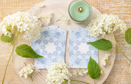 Deck with homemade divination Angel cards on wood table with hydrangea flower for decoration. Home...