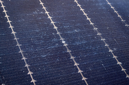 Close up view of damaged broken solar panel tempered glass cell. Stone dent in the middle with...