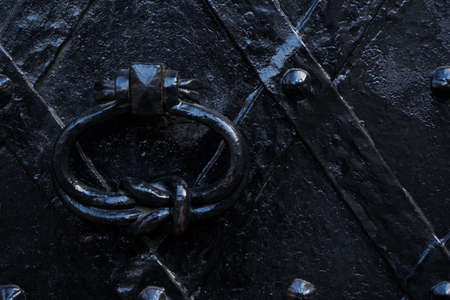 Door knocker on old iron doorの写真素材