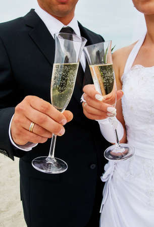 clink glasses by bride and groomの写真素材