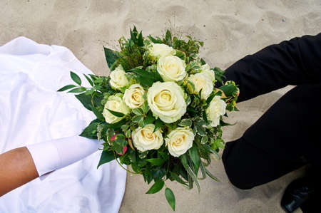 bride holding wedding bouquet with rosesの写真素材