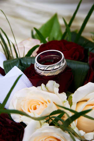 wedding bouquet with roses and ringsの写真素材