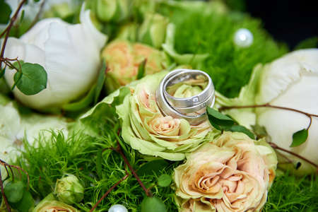 wedding bouquet with roses and ringsの写真素材