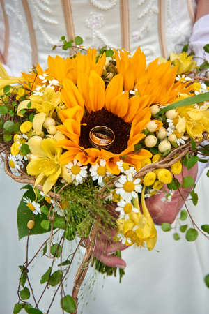 bride holding wedding bouquet with rosesの写真素材
