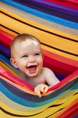 baby laughing in hammockの写真素材