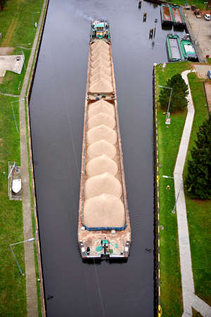 sand transport by boat on riverの写真素材