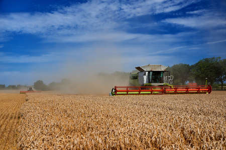 Wheat harvester machine at work on fieldのeditorial素材