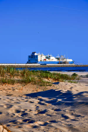 ÅwinoujÅcie, Poland - May-15-2022: LNG transportation vessel Maran Gas Apollonia while discharging at terminal for liquified gas, connections, equipment and pressure reducers at baltic sea. (Western Europe)のeditorial素材