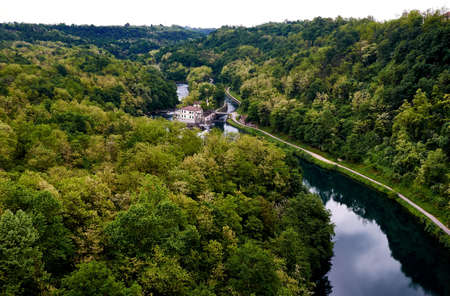 River Adda through a forest and a small house in Lomardi