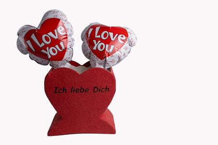 Two hearts as balloons with the words "I love you" are in a red heart with the words "I love you"の写真素材