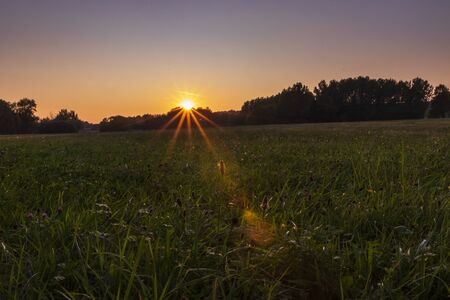 Sunset with beautiful sun star.の写真素材