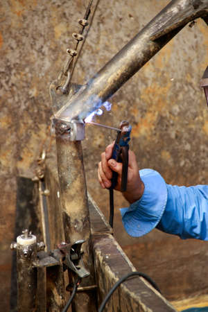 Welding a metal bracket to a frame with electric shit