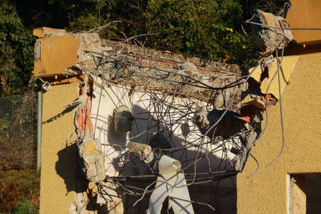 Concrete residues that are stuck to the structural steel after a ceiling has been demolished