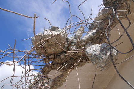 Concrete residues that are stuck to the structural steel after a ceiling has been demolished