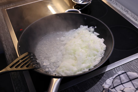 Onions are fried in a panの写真素材